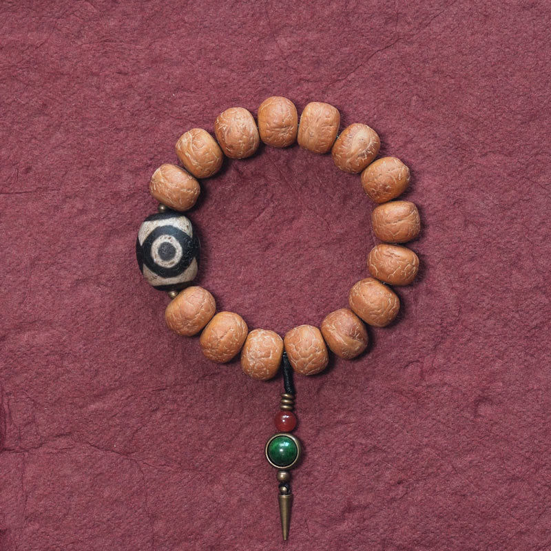 ATELIER-TIBET Bracelet Mala Bodhi 14 mm et Perles Dzi Artisanales La force symbolique des graines sacrées