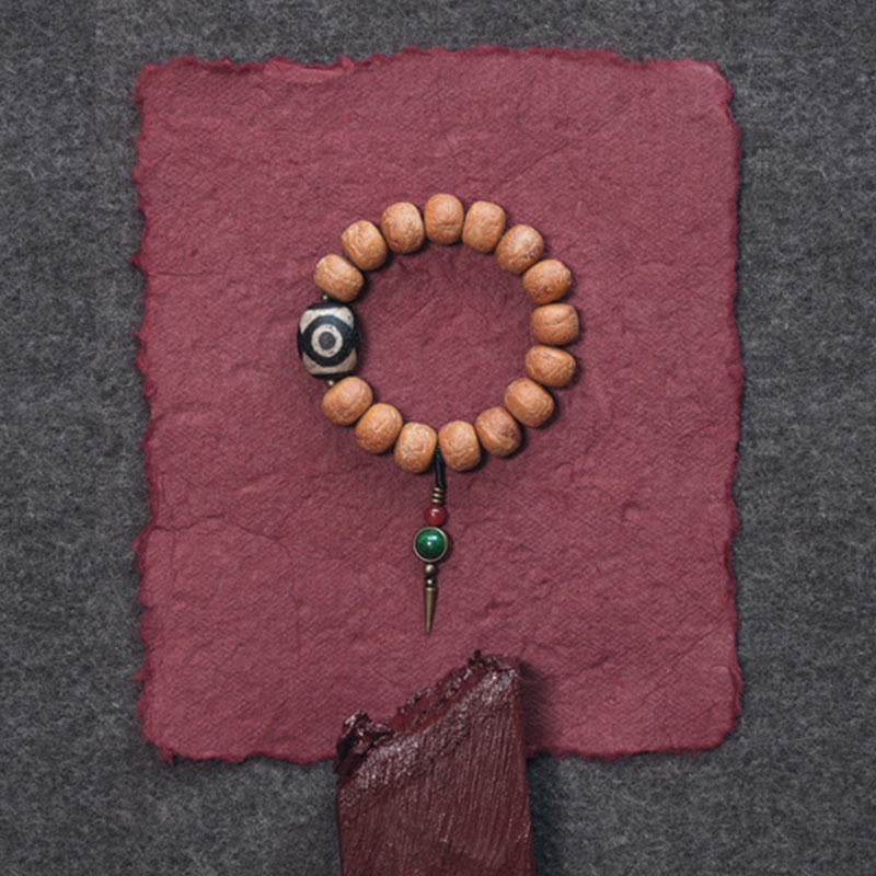 ATELIER-TIBET Bracelet Mala Bodhi 14 mm et Perles Dzi Artisanales La force symbolique des graines sacrées